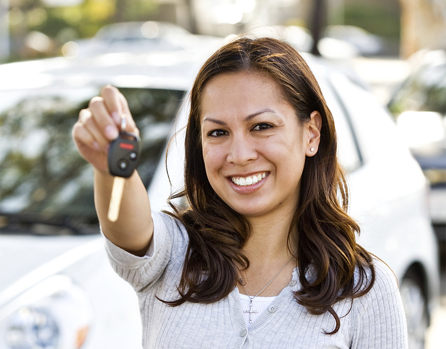 Girl holding out car keys